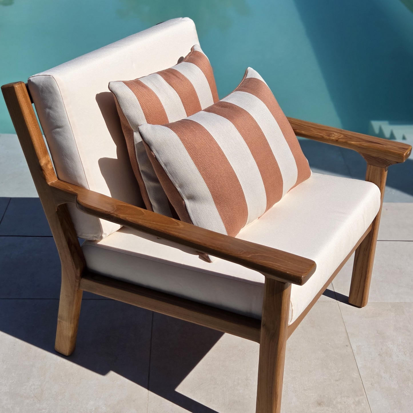 Premium Grade A teak lounge chair with weather-resistant ivory cushions for luxury outdoor mediterranean living.