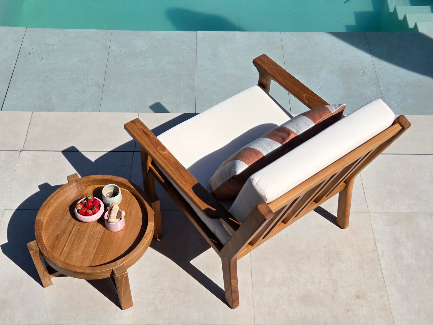 Premium Grade A teak lounge chair with weather-resistant ivory cushions for luxury outdoor mediterranean living.