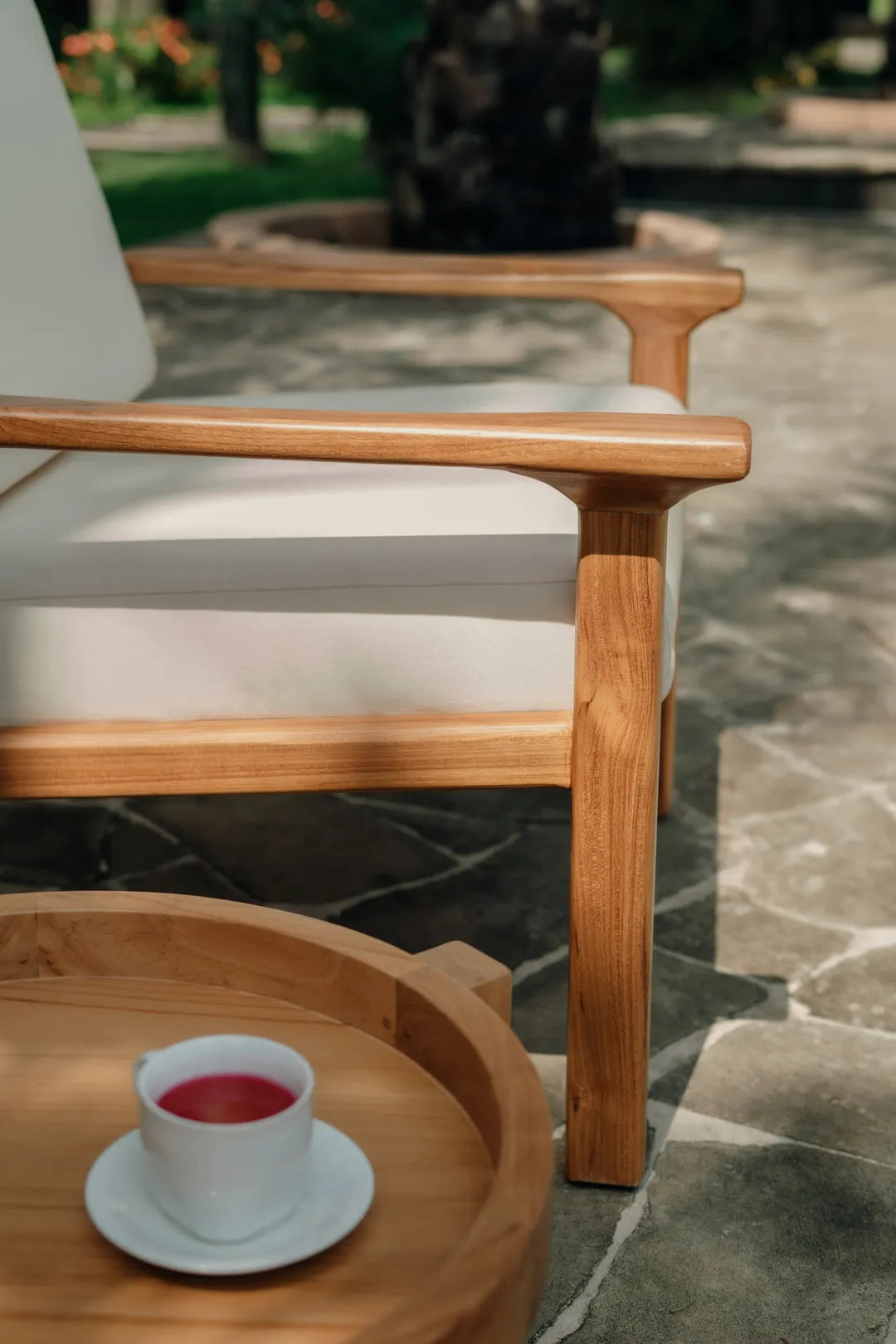 Matala lounge chair in Grade A teak with white outdoor cushions, featuring a boho and Scandinavian design.