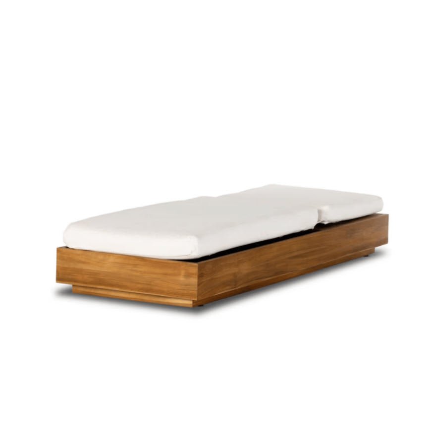 Laguna Sun Bed in solid teak with white cushion in fully flat position, product shot on white background.