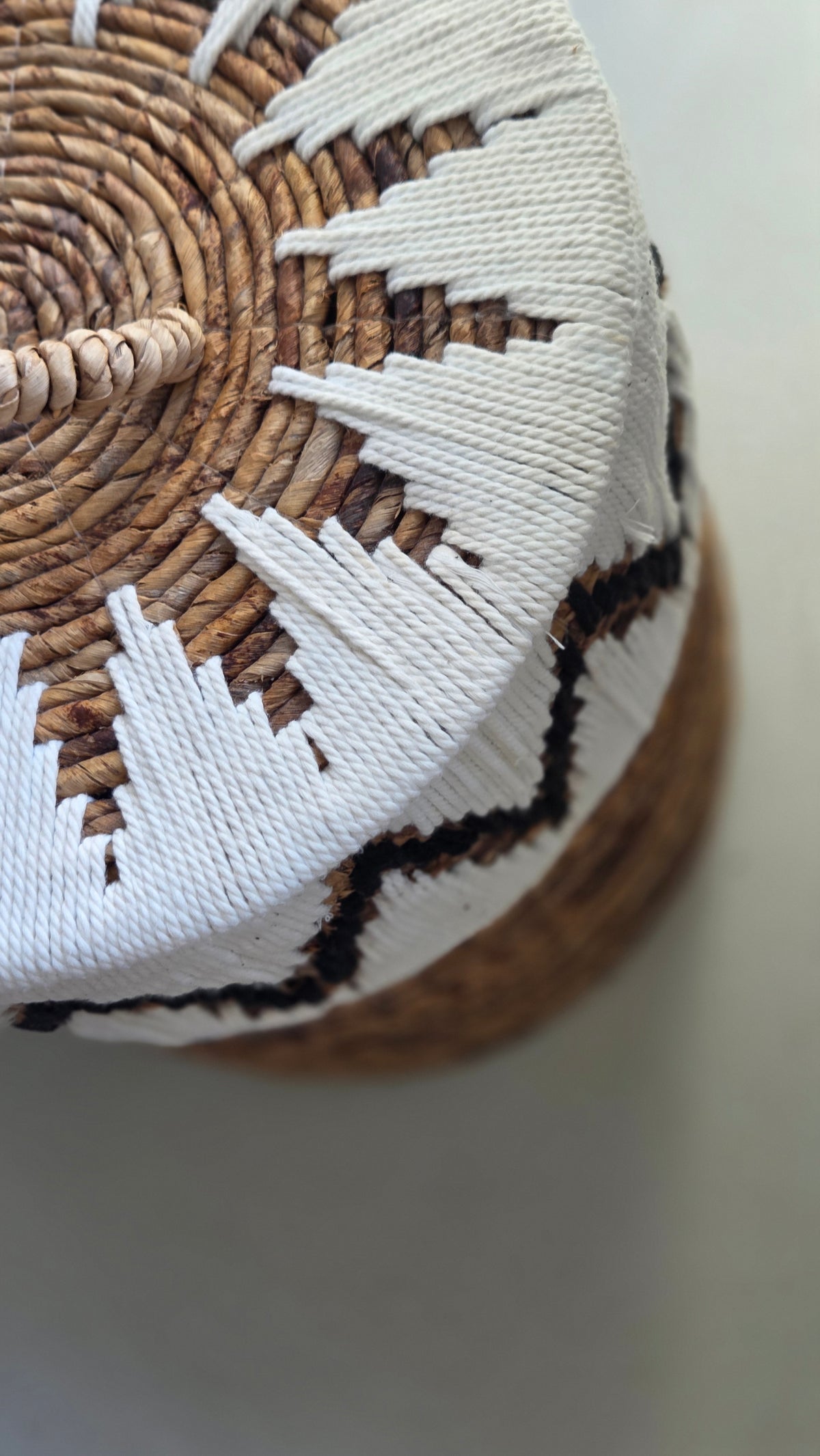 Top view of the Samuel handwoven abaca storage basket with fitted lid and natural rope handle.