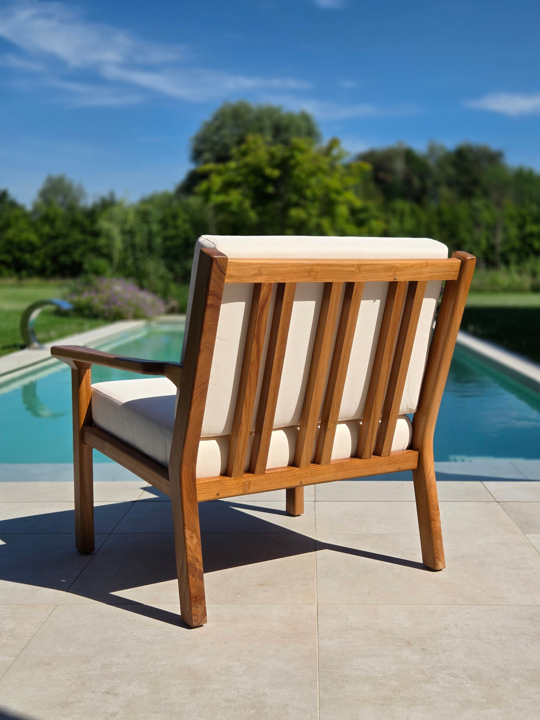 Premium Grade A teak lounge chair with weather-resistant ivory cushions for luxury outdoor mediterranean living.