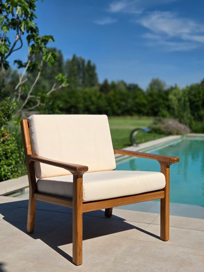 Premium Grade A teak lounge chair with weather-resistant ivory cushions for luxury outdoor mediterranean living.