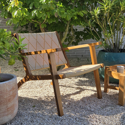 Elegant teak lounge chair with handcrafted woven detailing, creating a relaxed Mediterranean-inspired outdoor living space