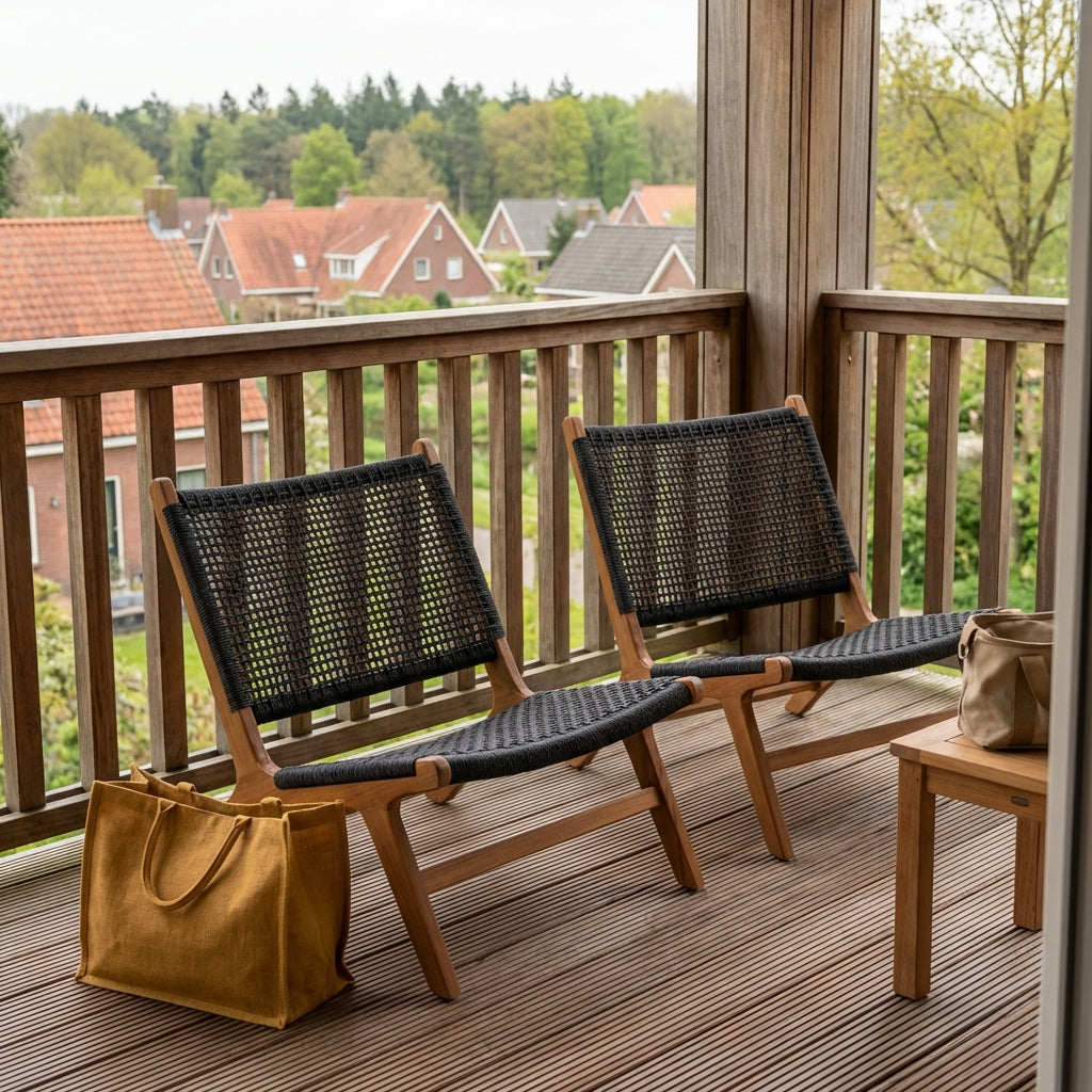Two woven outdoor lounge chairs on a wooden balcony overlooking a peaceful residential landscape, creating a relaxed and natural outdoor retreat.