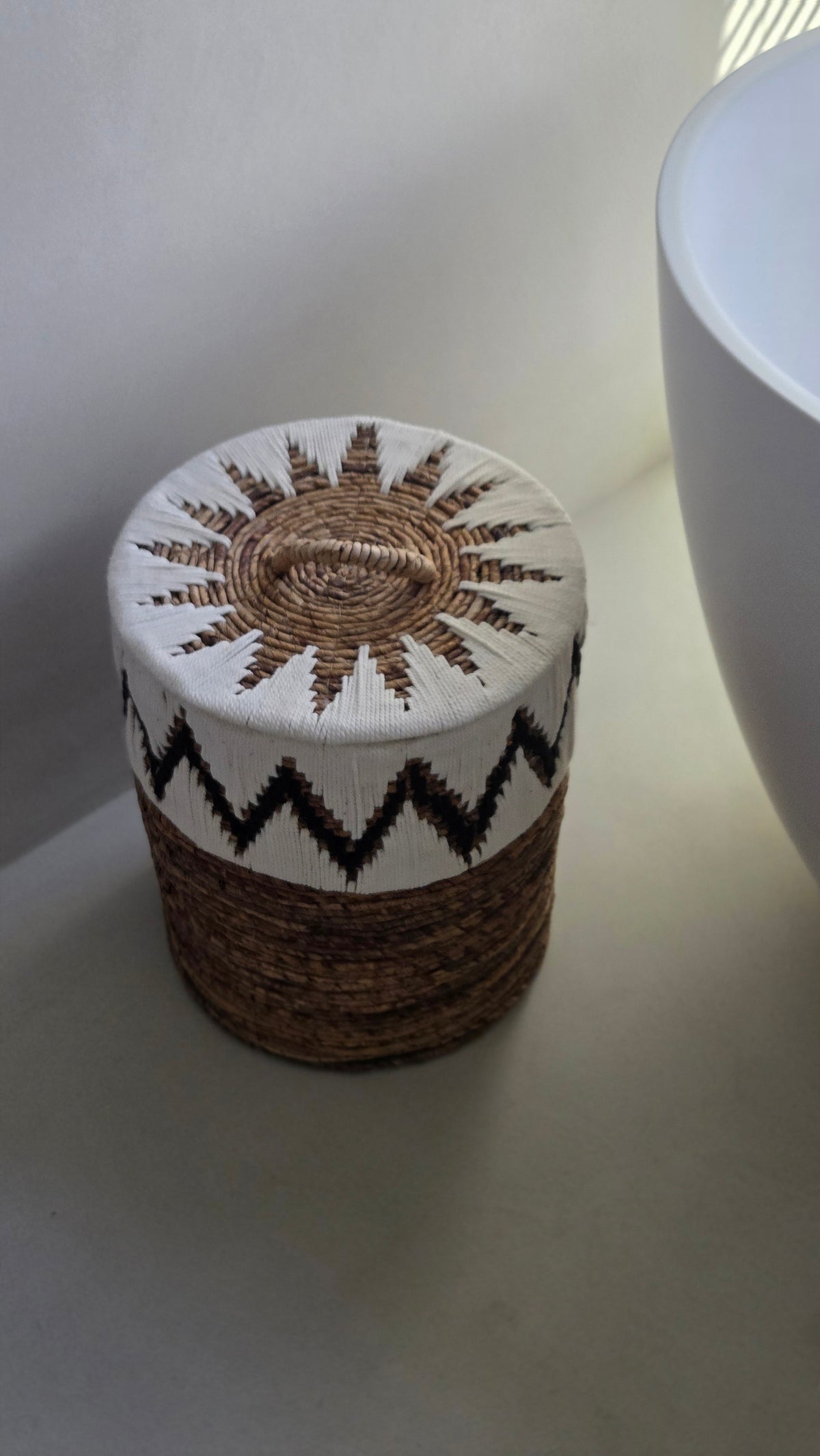 Top view of the Samuel handwoven abaca storage basket with fitted lid and natural rope handle.