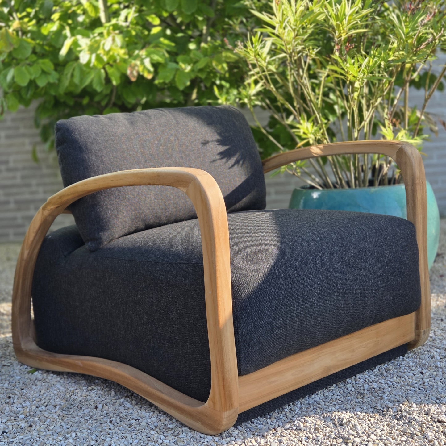 Premium Grade A teak outdoor lounge chair with weather-resistant charcoal cushions for stylish garden and terrace living